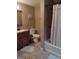 Bathroom features a vanity, toilet, tiled floor, and a bathtub with a tiled shower at 5840 Butner Rd, South Fulton, GA 30349