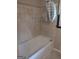Bathroom featuring a bathtub with tiled surround at 5840 Butner Rd, South Fulton, GA 30349