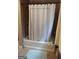 The bathtub with shower curtain offers a space for relaxation and hygiene at 5840 Butner Rd, South Fulton, GA 30349