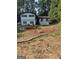 Charming two-story home with a landscaped front yard, black trim, and a manicured garden at 5840 Butner Rd, South Fulton, GA 30349