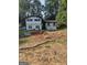 Charming two-story home with a landscaped front yard, black trim, and a manicured garden at 5840 Butner Rd, South Fulton, GA 30349