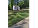 Exterior of outbuilding, with black trim and door, surrounded by lawn at 5840 Butner Rd, South Fulton, GA 30349