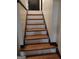 Staircase with wooden steps and dark trim at 5840 Butner Rd, South Fulton, GA 30349