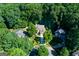Overhead view of a tree-lined property with a two-story brick home and lush landscaping at 3245 Bywater Trl, Roswell, GA 30075