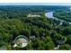 An aerial view of the wooded lot features a traditional brick home with a two-car garage at 3245 Bywater Trl, Roswell, GA 30075