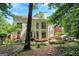 Large backyard with lush trees, a patio dining set, a hammock, and manicured landscaping, offering an outdoor oasis at 3245 Bywater Trl, Roswell, GA 30075