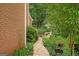 An inviting stone pathway leads to a private garden area in the wooded backyard at 3245 Bywater Trl, Roswell, GA 30075