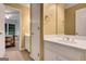 Bathroom featuring a white vanity, mirror, and doorway to bedroom suite at 3245 Bywater Trl, Roswell, GA 30075