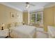 Comfortable bedroom featuring a quaint window seat, ceiling fan, and bright natural light at 3245 Bywater Trl, Roswell, GA 30075