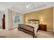 Cozy bedroom with a tray ceiling, large windows, and a comfortable queen-size bed at 3245 Bywater Trl, Roswell, GA 30075