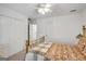 Spacious bedroom showcasing a ceiling fan, closet doors, and a view into an adjacent room at 3245 Bywater Trl, Roswell, GA 30075
