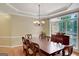 Formal dining room featuring a large window, chandelier, and ample space for entertaining guests at 3245 Bywater Trl, Roswell, GA 30075