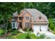 Beautiful brick home with a well-manicured lawn and two car garage at 3245 Bywater Trl, Roswell, GA 30075