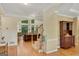 Inviting foyer featuring hardwood floors, staircase, and an open view into the living room with large windows at 3245 Bywater Trl, Roswell, GA 30075