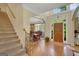 Spacious foyer featuring hardwood floors, staircase, and a view into the dining area and front entrance at 3245 Bywater Trl, Roswell, GA 30075