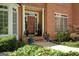 Charming front entrance with brick facade, decorative columns, and lush landscaping adding curb appeal at 3245 Bywater Trl, Roswell, GA 30075