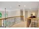 Bright hallway showcasing decorative railing and built-in shelving, leading to other rooms in the home at 3245 Bywater Trl, Roswell, GA 30075