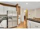 Spacious kitchen with a stainless steel refrigerator and black countertops at 3245 Bywater Trl, Roswell, GA 30075