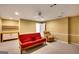 Relaxing living room featuring a futon, comfortable armchair, and built-in cabinet for storage at 3245 Bywater Trl, Roswell, GA 30075