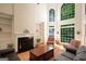 Elegant living room with fireplace and soaring windows offers great light and views at 3245 Bywater Trl, Roswell, GA 30075