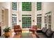 Bright living room with large windows, hardwood floors, and comfortable seating area at 3245 Bywater Trl, Roswell, GA 30075