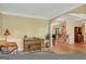 Elegant living room featuring hardwood floors, piano, and a comfortable seating area leading to the foyer and staircase at 3245 Bywater Trl, Roswell, GA 30075