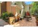 Spacious outdoor patio with dining table, water fountain, brick elements, and lush landscaping, creating an outdoor space at 3245 Bywater Trl, Roswell, GA 30075