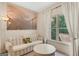 Inviting sitting room with a striped sofa, large window, and unique artwork at 3245 Bywater Trl, Roswell, GA 30075