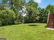 Lush backyard with a trampoline, ample green space, and natural surroundings at 942 Marta Crane Dr, Lawrenceville, GA 30045