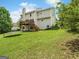 Expansive backyard with lush lawn, mature trees, deck and space for outdoor activities at 942 Marta Crane Dr, Lawrenceville, GA 30045