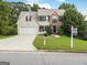 Charming two-story home featuring a manicured lawn, a two-car garage and a traditional brick facade at 942 Marta Crane Dr, Lawrenceville, GA 30045