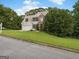 Attractive two-story home with a two-car garage nestled among mature trees on a sunny day at 942 Marta Crane Dr, Lawrenceville, GA 30045