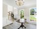 Bright foyer with chandelier, staircase, and large windows at 942 Marta Crane Dr, Lawrenceville, GA 30045