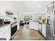 Modern kitchen with stainless steel appliances, granite countertops, and a view of a cozy living area at 942 Marta Crane Dr, Lawrenceville, GA 30045