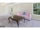 Bright living area showcasing a soft sofa, classic coffee table, and natural light from nearby windows at 942 Marta Crane Dr, Lawrenceville, GA 30045