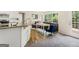 Cozy living area with a view from the kitchen featuring a comfortable sofa and natural light at 942 Marta Crane Dr, Lawrenceville, GA 30045