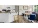 Inviting kitchen view with a breakfast bar leading to a comfortable living space featuring a plush sofa at 942 Marta Crane Dr, Lawrenceville, GA 30045