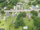 An aerial of a property showcasing its well-kept lawn, trees, proximity to nearby street, and neighborhood at 178 S Old Highway 27, Roopville, GA 30170
