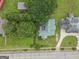 Overhead view of a home with a green metal roof surrounded by lush greenery and a well-kept lawn at 178 S Old Highway 27, Roopville, GA 30170