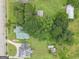 Aerial view of home with green metal roof showcasing its landscaping, mature trees, and surrounding neighborhood at 178 S Old Highway 27, Roopville, GA 30170