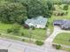 Aerial view of home featuring a green metal roof, lush lawn, and mature trees on a well-maintained lot at 178 S Old Highway 27, Roopville, GA 30170