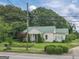 Charming home exhibits a well-maintained lawn, beautiful landscaping, and mature trees, enhancing the overall curb appeal at 178 S Old Highway 27, Roopville, GA 30170