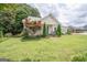 Charming home exhibits a well-maintained lawn, beautiful landscaping, and mature trees, enhancing the overall curb appeal at 178 S Old Highway 27, Roopville, GA 30170
