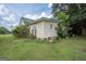 Rear view of house, light yellow siding, surrounded by trees and greenery at 178 S Old Highway 27, Roopville, GA 30170