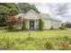 Charming home boasts a lush green lawn, colorful flowerbeds, and healthy landscaping, creating an inviting curb appeal at 178 S Old Highway 27, Roopville, GA 30170