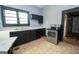 Practical kitchen featuring functional appliances and a sink with natural light, offers a workspace for meal preparation at 178 S Old Highway 27, Roopville, GA 30170