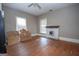 Spacious living room with original hardwood floors, fireplace, and natural light offers a cozy and inviting atmosphere at 178 S Old Highway 27, Roopville, GA 30170