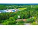 Stunning aerial view of a residential area surrounded by lush green trees and community school at 3150 Stratford Green Pl, Avondale Estates, GA 30002
