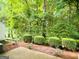Beautiful backyard featuring a wooded landscape and garden hedging at 3150 Stratford Green Pl, Avondale Estates, GA 30002