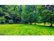 Lush green backyard surrounded by vibrant trees, ideal for nature lovers and peaceful outdoor activities at 3150 Stratford Green Pl, Avondale Estates, GA 30002
